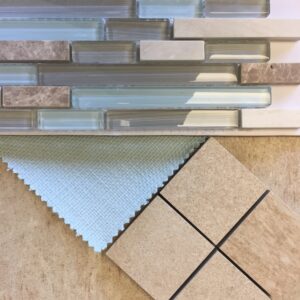 Linear mosaic tile in beiges, gray, and aqua; aqua fabric; beige tan tile square mosaic and background tile