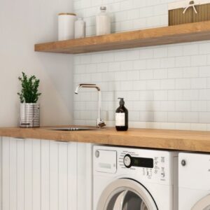 Laundry room with white appliances, white subway tile backsplash, sink, wooden shelving and countertop