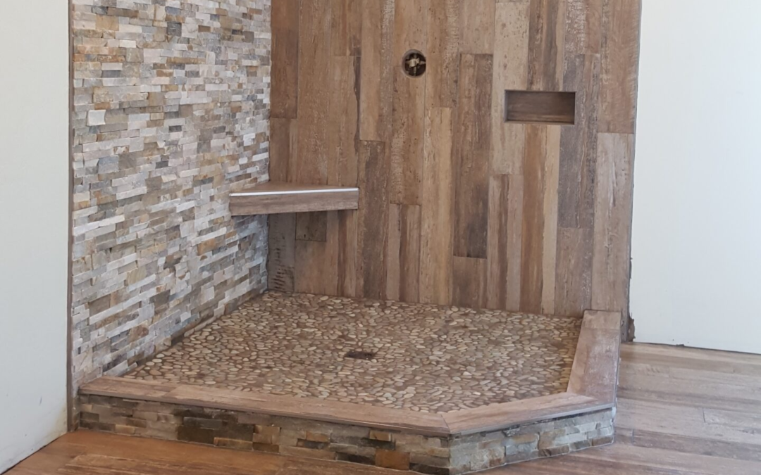 Shower with wood-look tile, quartzite ledger, and pebbles